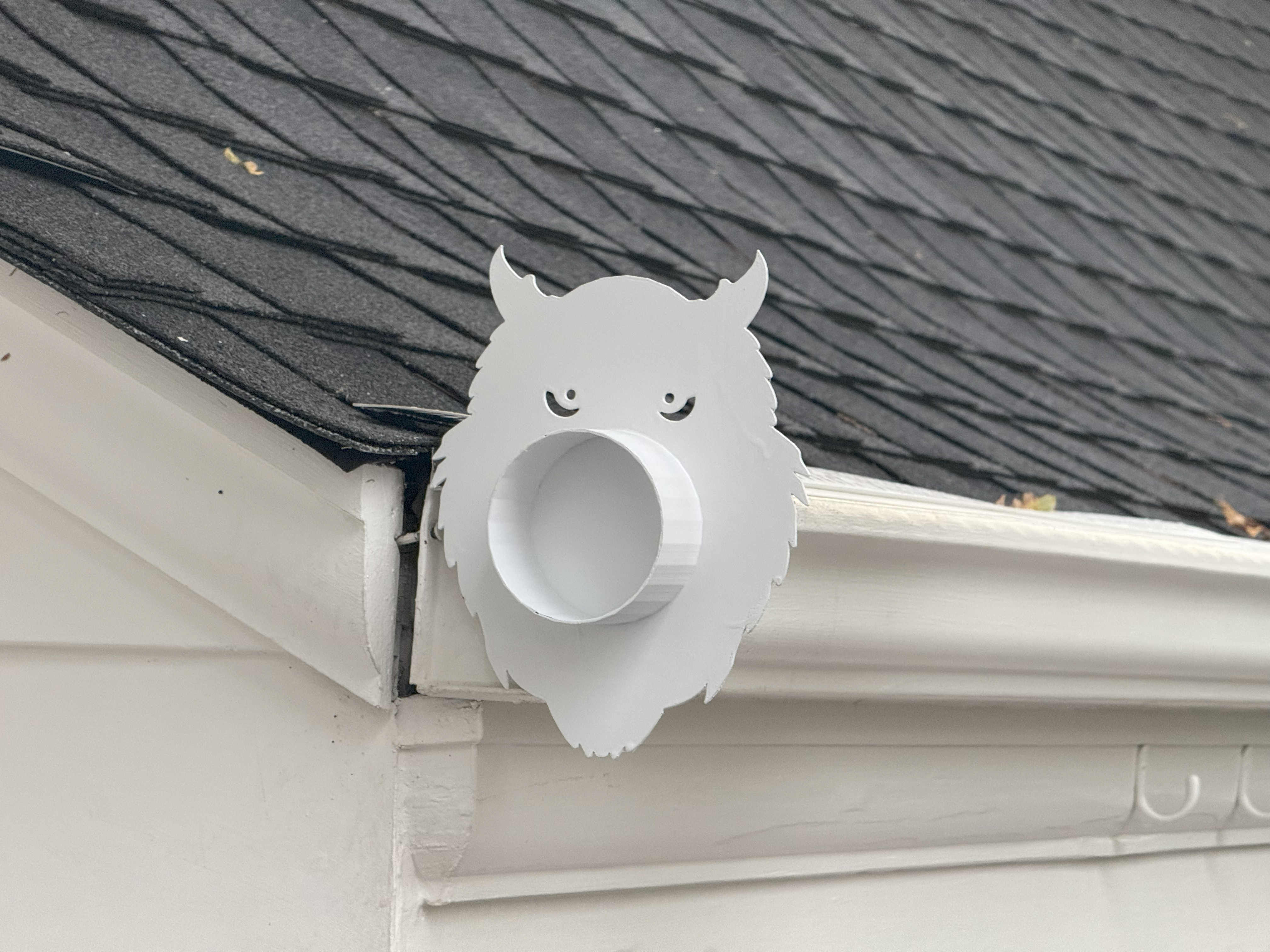 Decorative gutter end cap installed on K-style gutter